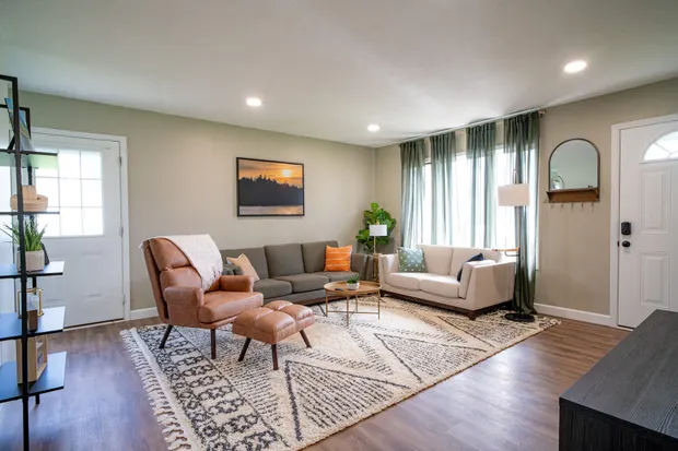 Living room with two sofas and a leather accent chair.