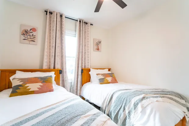 Two twin beds in a bright bedroom.