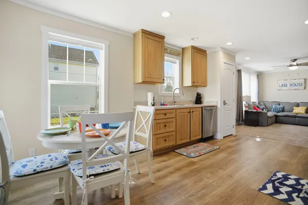 Kitchen and dining area with a window and light wood-look floors.