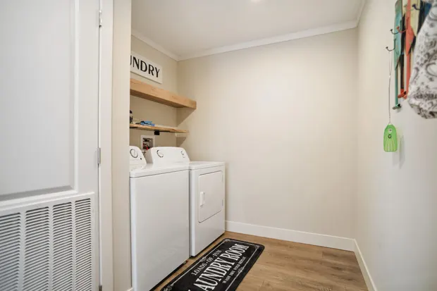 Dedicated laundry room with a full-size washer and dryer.