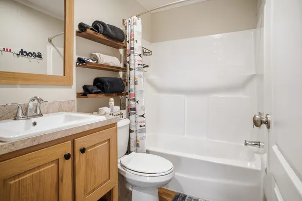 Second full bathroom with a tub-shower combo and a vanity.