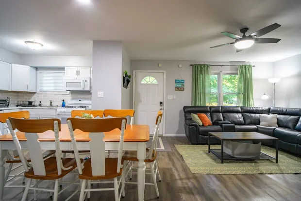 Open living and dining area with the kitchen beyond.