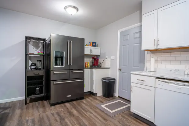 Kitchen with a stainless refrigerator and ample cabinetry.