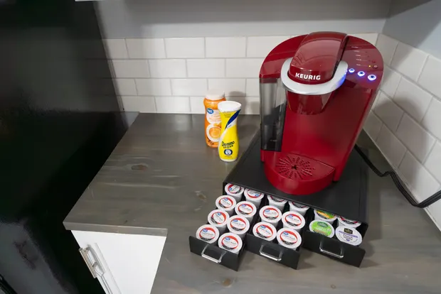 Coffee bar with a Keurig machine and an assortment of K-Cups.