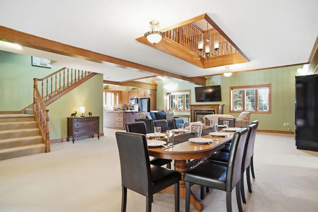 Olive Street Carriage House, vacation rental near Summit Motorsports Park, Norwalk Ohio — the open living and dining room with a table that seats eight.