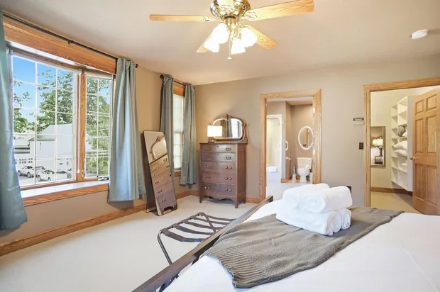 Primary bedroom with en-suite bathroom, walk-in closet, and large window.