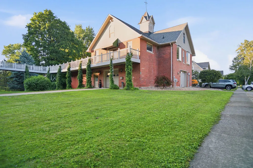 Olive Street Carriage House, vacation rental near Summit Motorsports Park, Norwalk Ohio — the red brick 1905 carriage house with its wraparound balcony.
