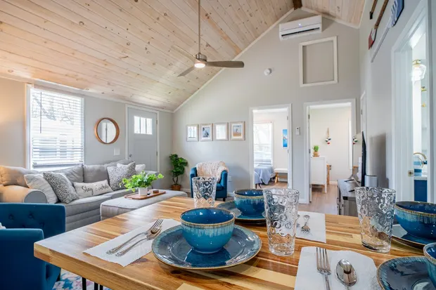 Wooden dining table set with blue ceramic bowls.