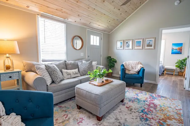 Living room with a grey sectional sofa and blue accent chairs.