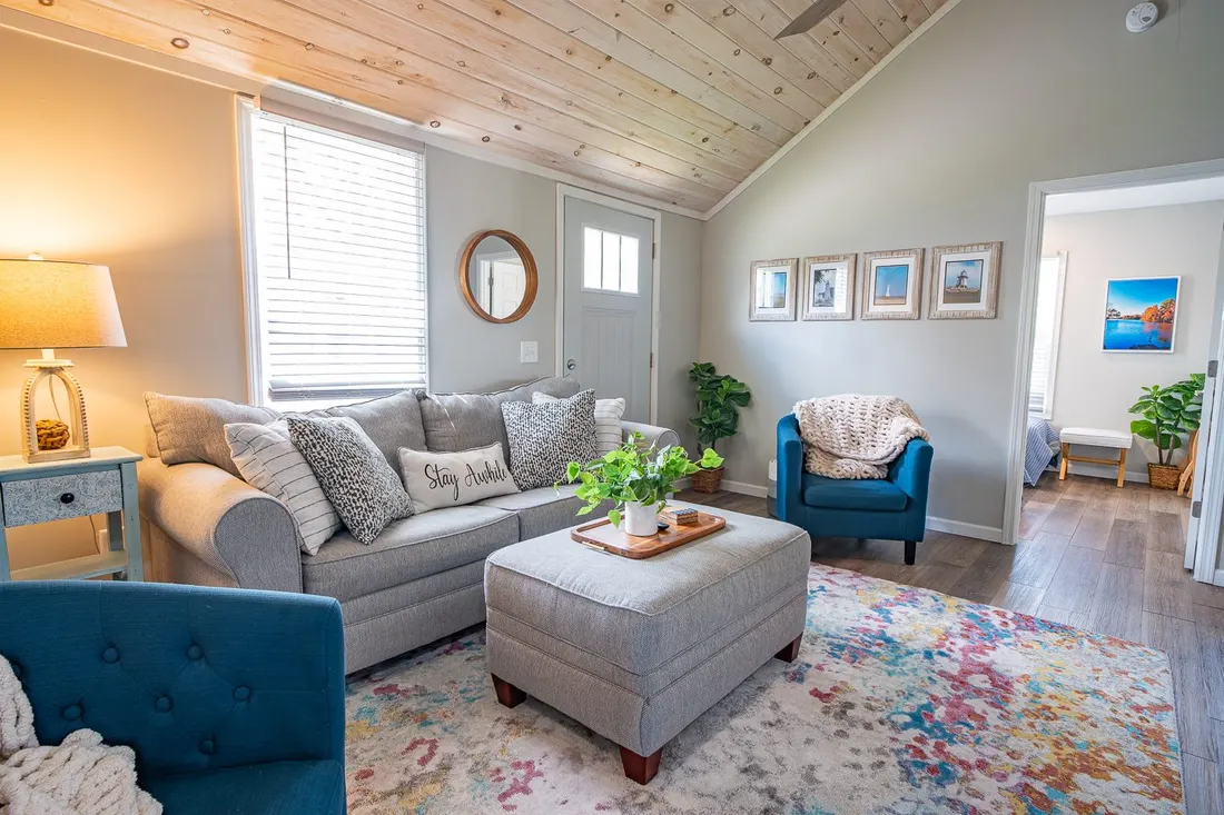 Living room with a grey sectional sofa and blue accent chairs.