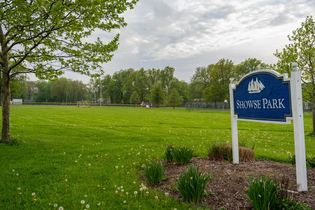 Showse Park sign in a grassy lakefront field.