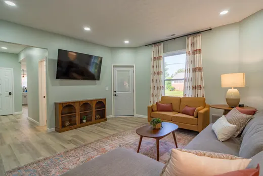 Living room with a sectional sofa and a patterned area rug.