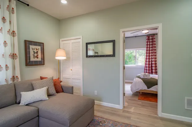 Living room sectional with a doorway through to a bedroom.