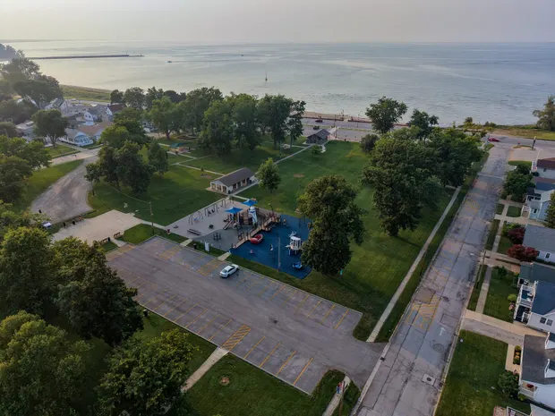 Aerial of the nearby lakefront park with a playground and Lake Erie beyond.