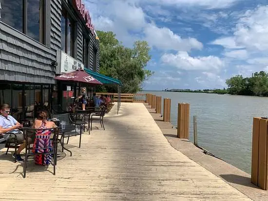 Outdoor waterfront seating at a restaurant on the Huron River.