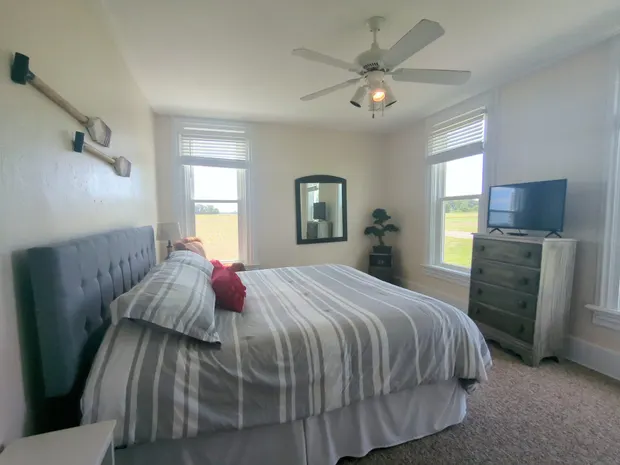 Downstairs king bedroom with an upholstered headboard.