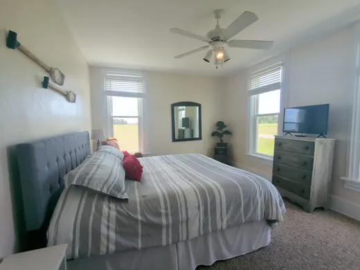 Downstairs king bedroom with an upholstered headboard.