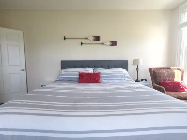 King bedroom with a dresser and mirror.