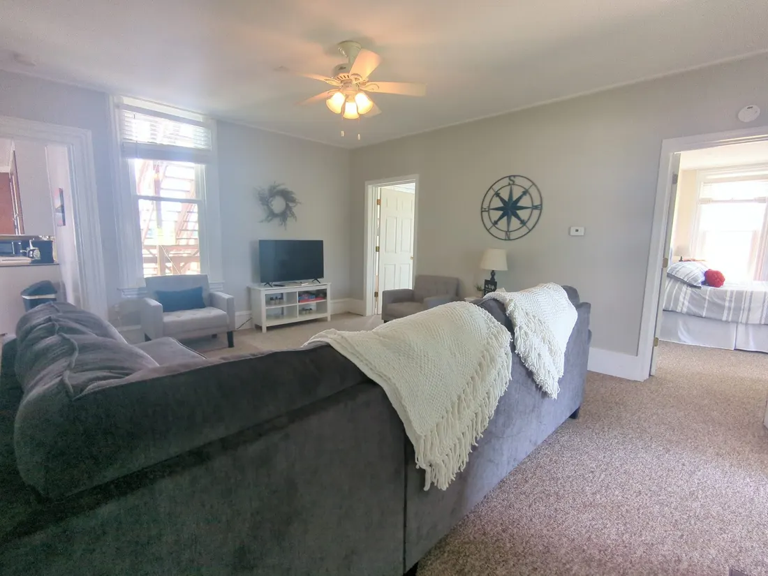 Living room with a large grey sectional and a TV.