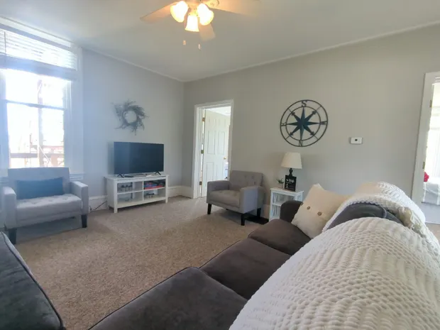 Living room with grey seating and chairs.