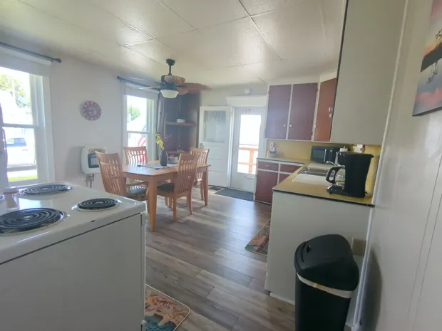 Combined kitchen and dining room with a wooden table.