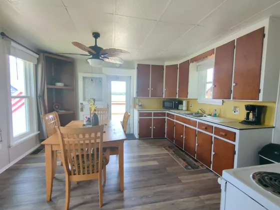 Kitchen with wood cabinets and a dining table.