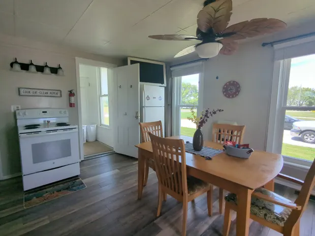 Kitchen and dining area with a wooden table and chairs.