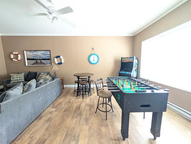 Game room with a foosball table and bar-height seating.