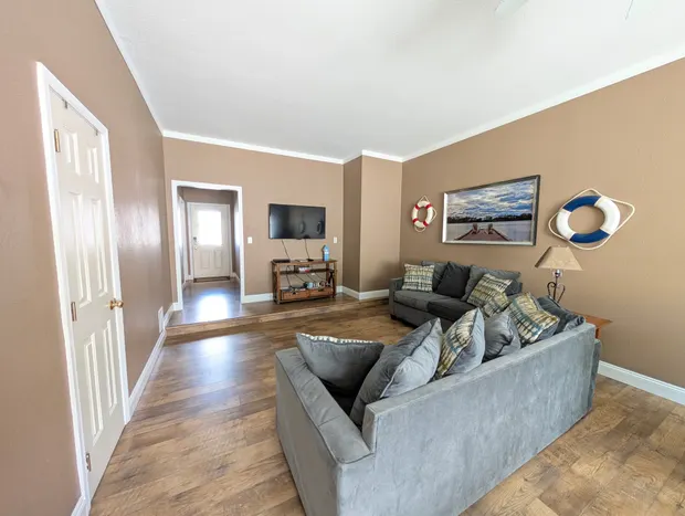 Game room seating area with a sofa and a media console.