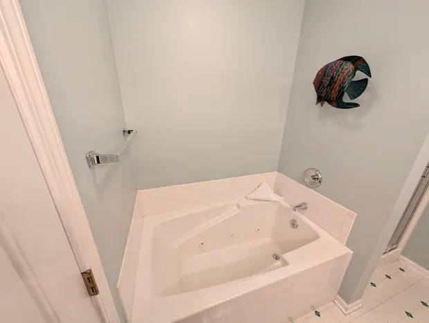 Bathroom with a large corner soaking tub.