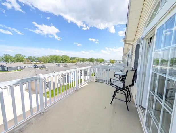 Private third-floor balcony with chairs overlooking the neighbourhood.