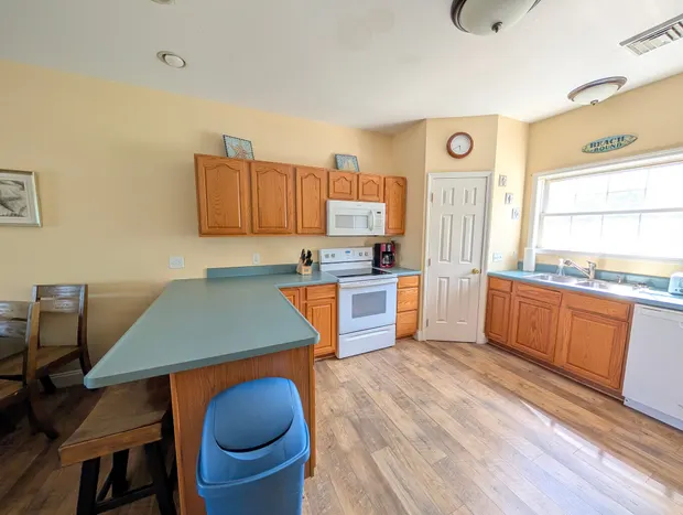Kitchen from another angle with the microwave and range.