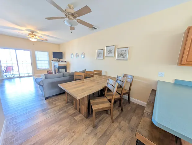 Dining table with chairs beside the open living area.