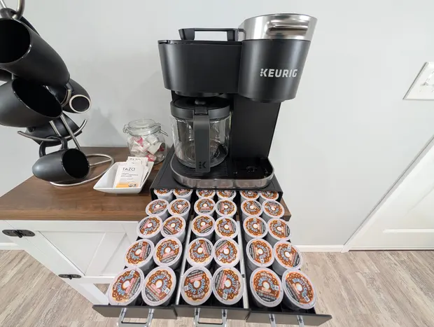 Coffee station with a Keurig and an open pod drawer.
