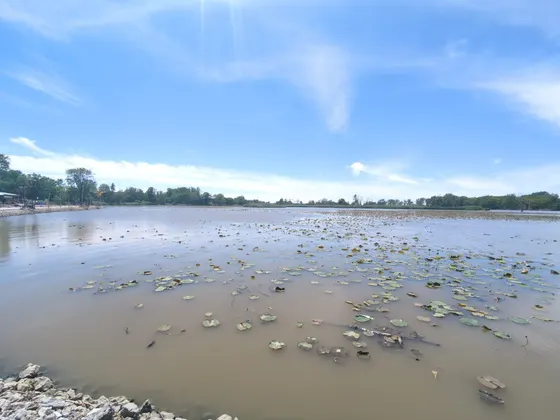 Wide view of the calm Sandusky River under a bright blue sky.