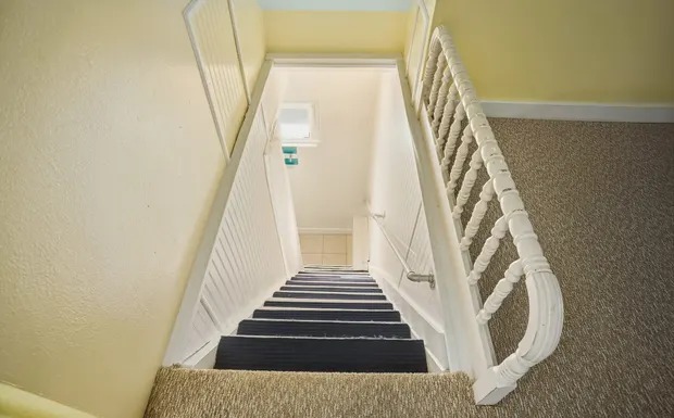 Steep, narrow staircase leading up to the sleeping loft.